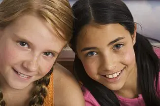 Two smiling preteen girls