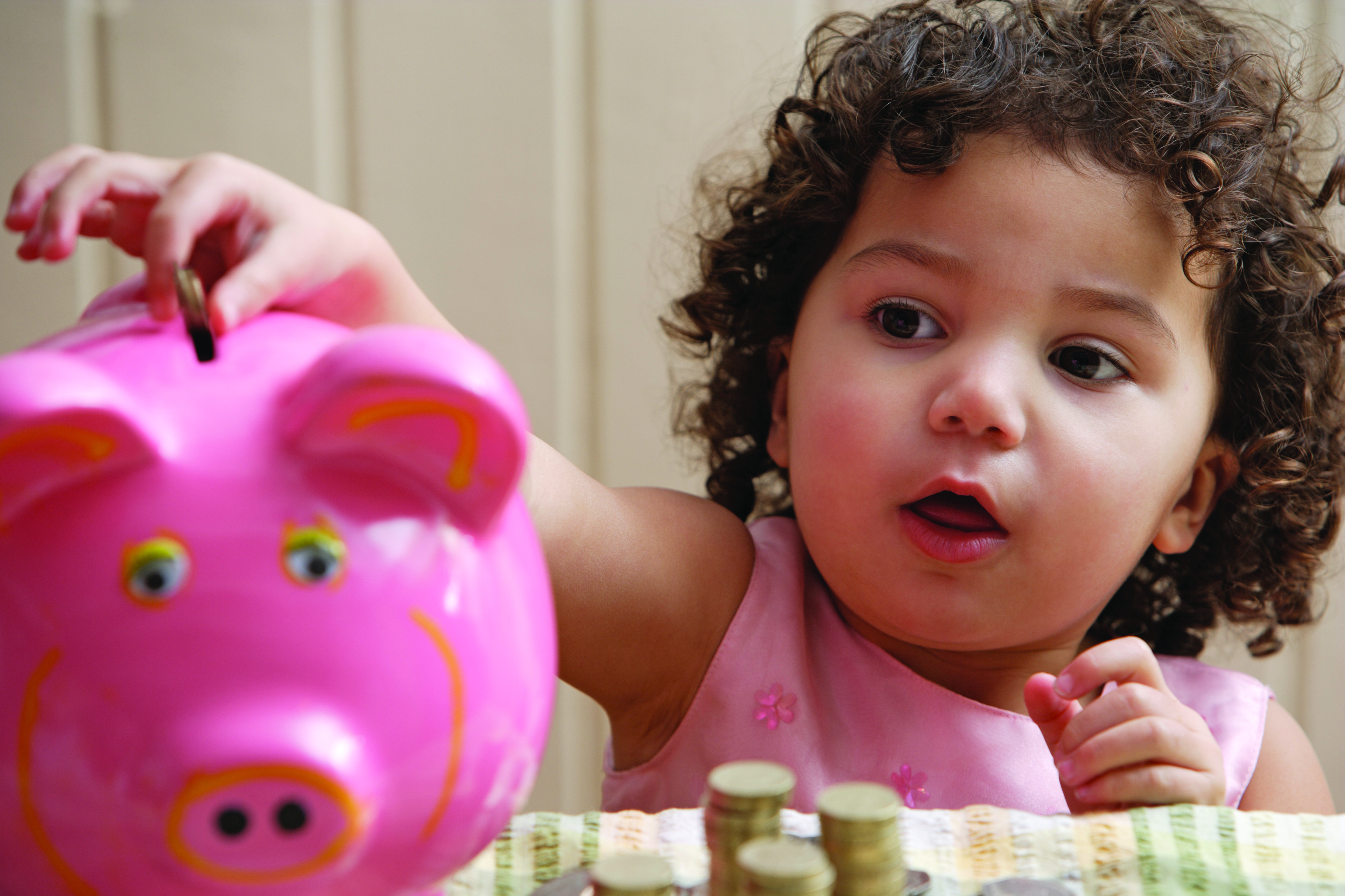 Cute girl with piggy bank
